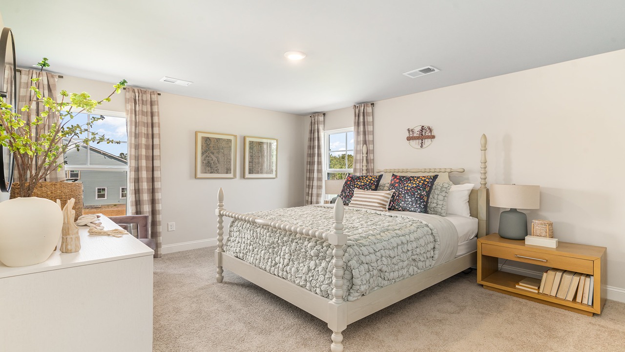 Spacious primary bedroom in New Construction Home by D.R. Horton includes Modern Design finishes and quiet rear-facing windows.