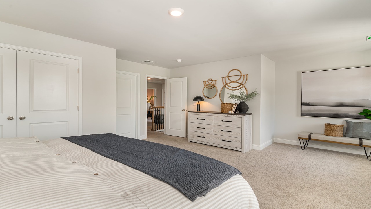 Bright and open owner's bedroom in Copper Grove at Harpers Mill overlooking the backyard, en-suite bathroom, Walk-in closet.