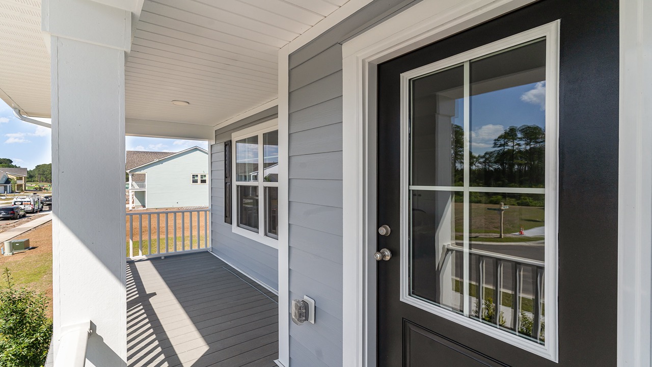 Practical upper-level porch design in D.R. Horton home with views of the front street