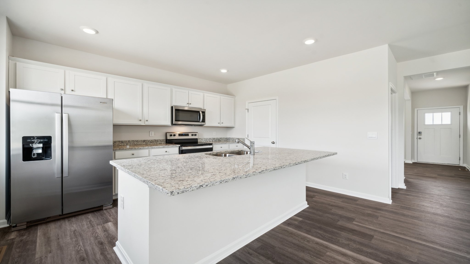 Central kitchen island with dining crafted to anchor the home with pantry, meal prep zones, guest and everyday gathering