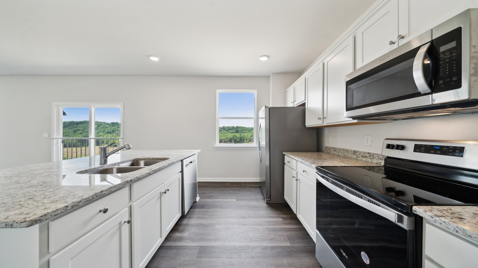 Kitchen in this New Home features a large island with seating, multi-prep zones, New appliances, and Modern Design finishes.
