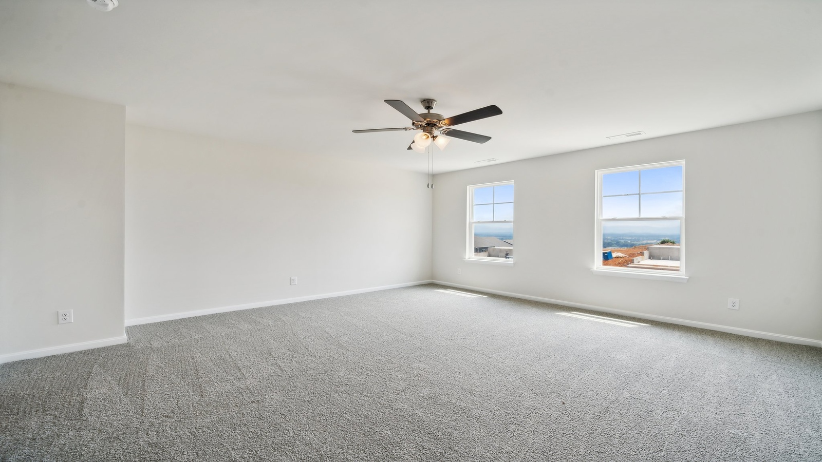 Spacious primary bedroom in our New Construction Home includes Modern Design finishes, quiet rear-facing windows.