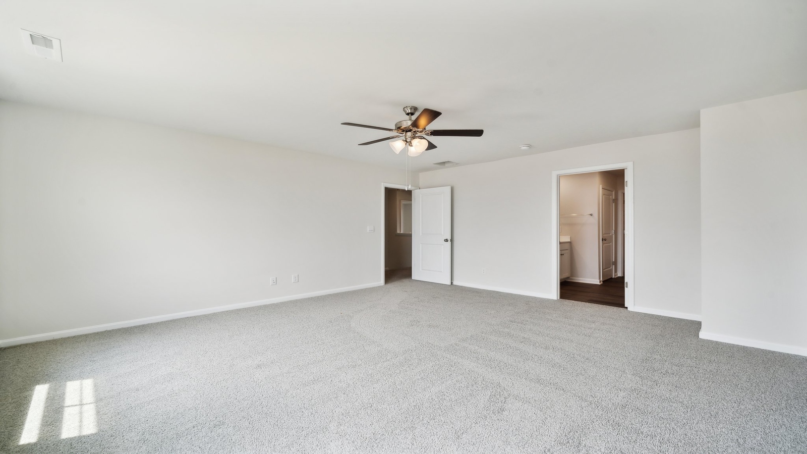 Main bedroom in New Build Home in Brewers Meadows South with stylish carpeting, ensuite bathroom, walk-in closet