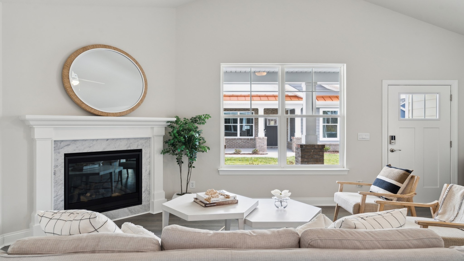 Main-level living room offers a bright space with electric fireplace and Open Concept connection to kitchen and living spaces