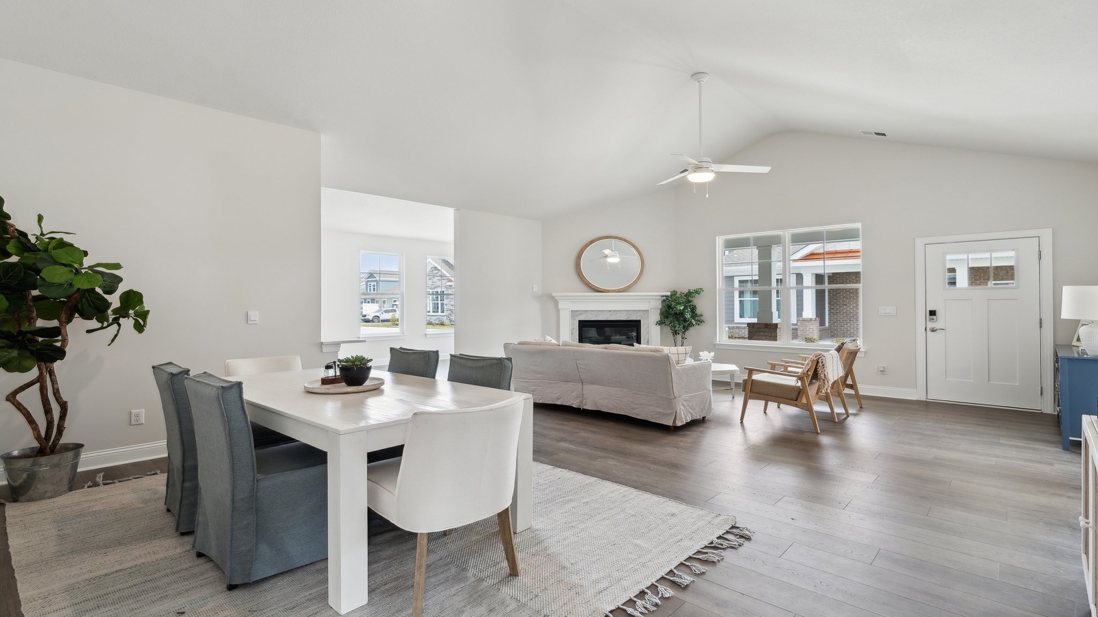 Main-level living-dining areas offers a bright space, an electric fireplace, and Open Concept connections throughout