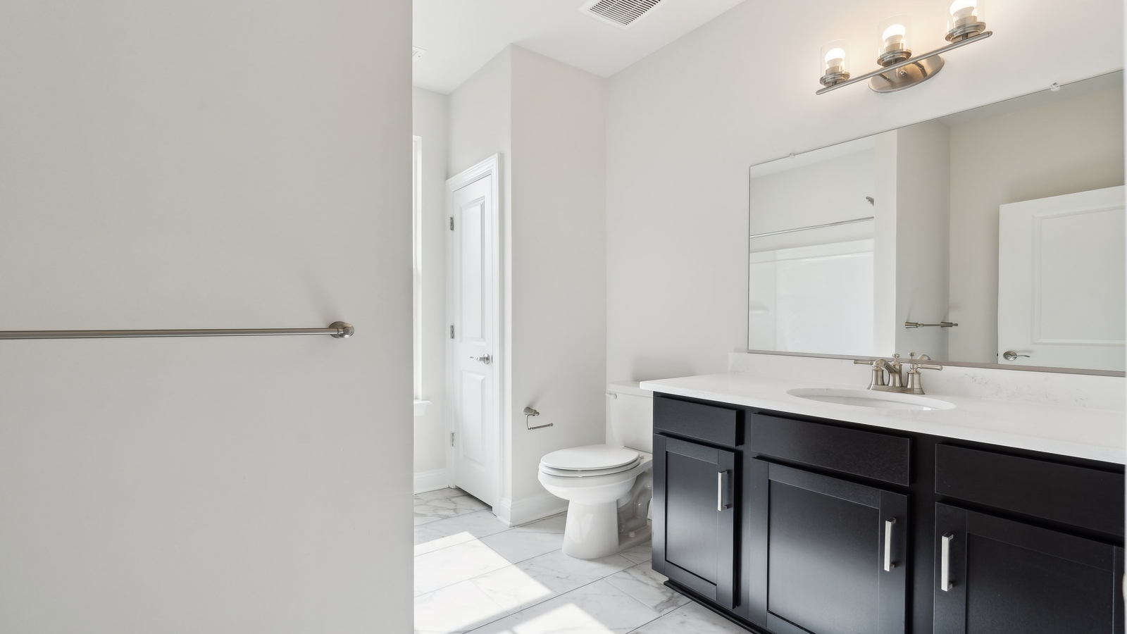 New Home showcases a D.R. Horton ensuite bathroom with quality flooring, open layout to shower-tub, and walk-in closet