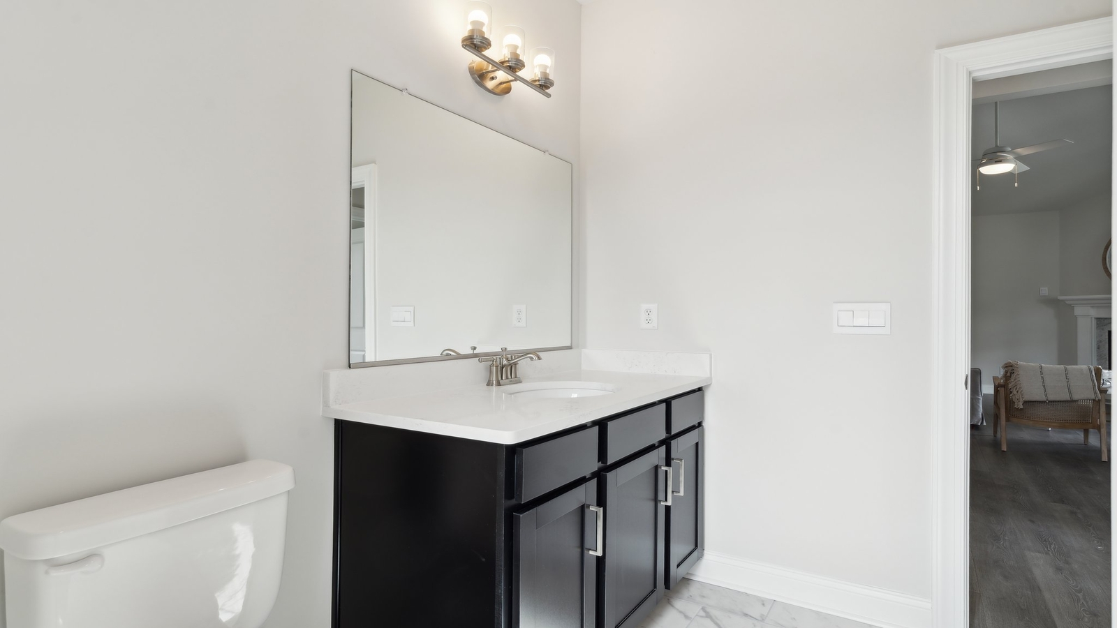 Primary bathroom in this New Build Home includes extended vanity, quality cabinets, walk-in closet and spa-style layout