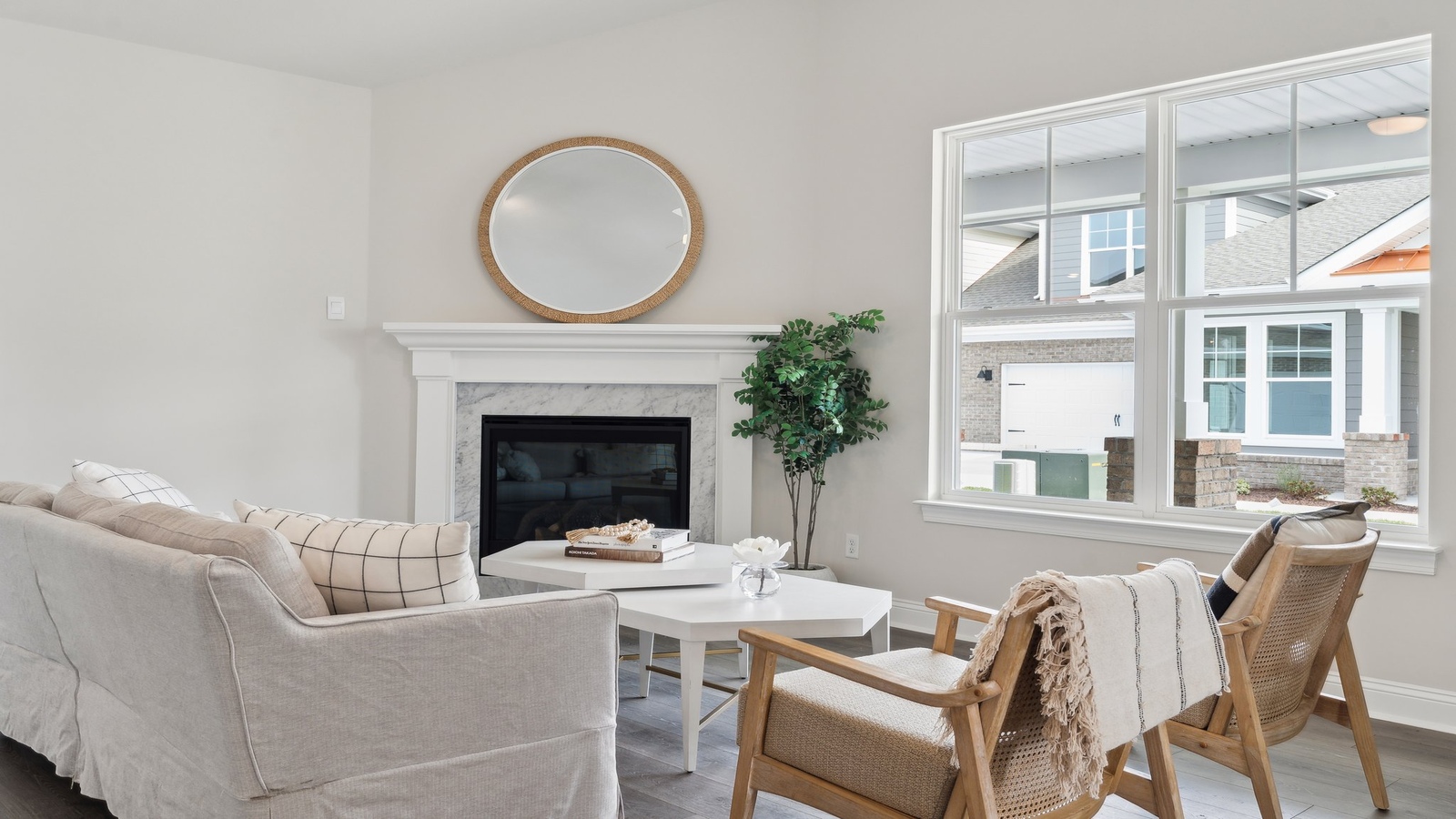 Main living zone with easy access near kitchen, dining area, and an electric fireplace in Retreat at Edinburgh Farms