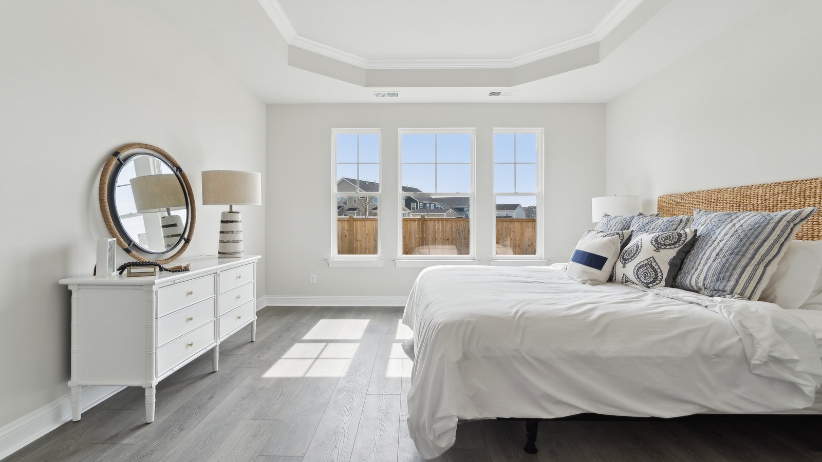 Bright and open primary bedroom in Retreat at Edinburgh Farms with walk-in closet, en-suite bath, large window overlooking backyard.