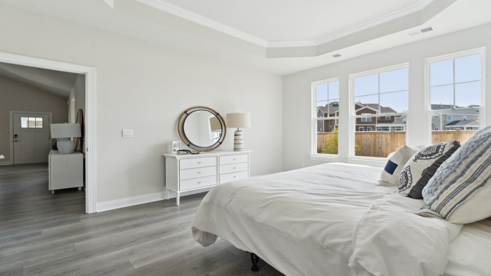 Owner’s suite offers natural window light, a spa-inspired en-suite bathroom, and a walk-in closet for everyday comfort