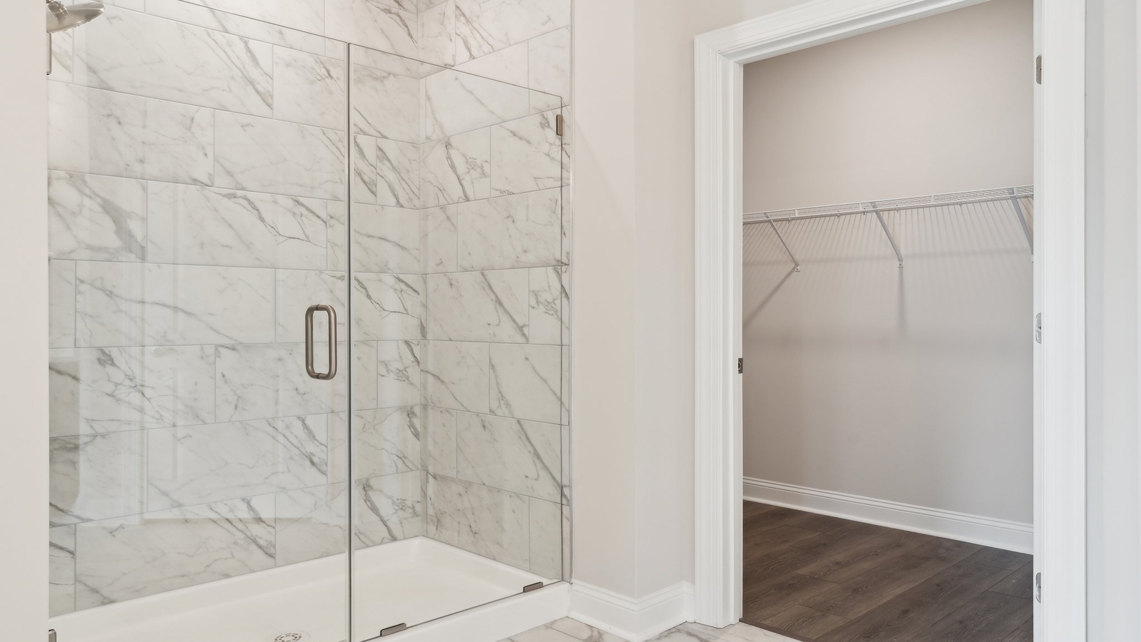 Primary bedroom walk-in closet in the ensuite enjoys ample space for clothes and accessories