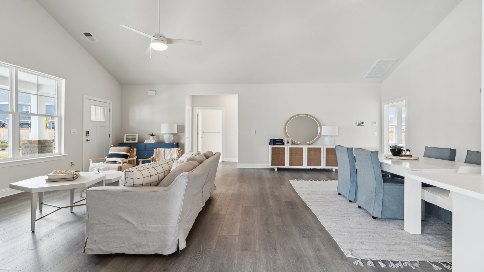 Living room, kitchen, and dining area function as one cohesive main space at Retreat at Edinburgh Farms by D.R. Horton