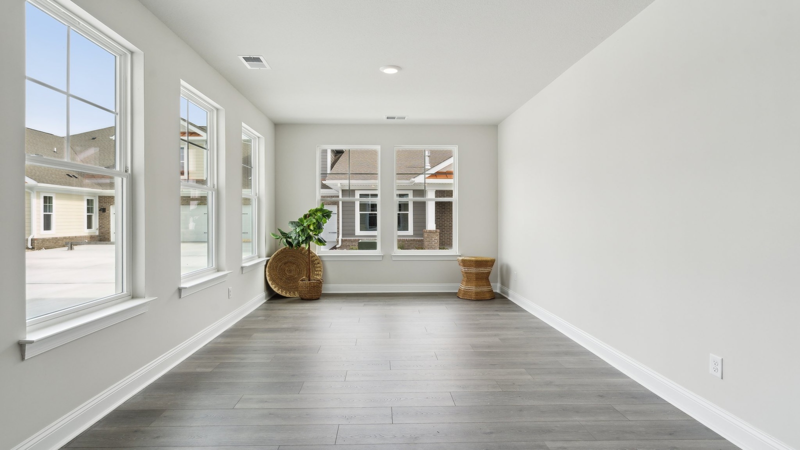 Connected main living area at Retreat at Edinburgh Farms emphasizing openness between kitchen, dining, and great room