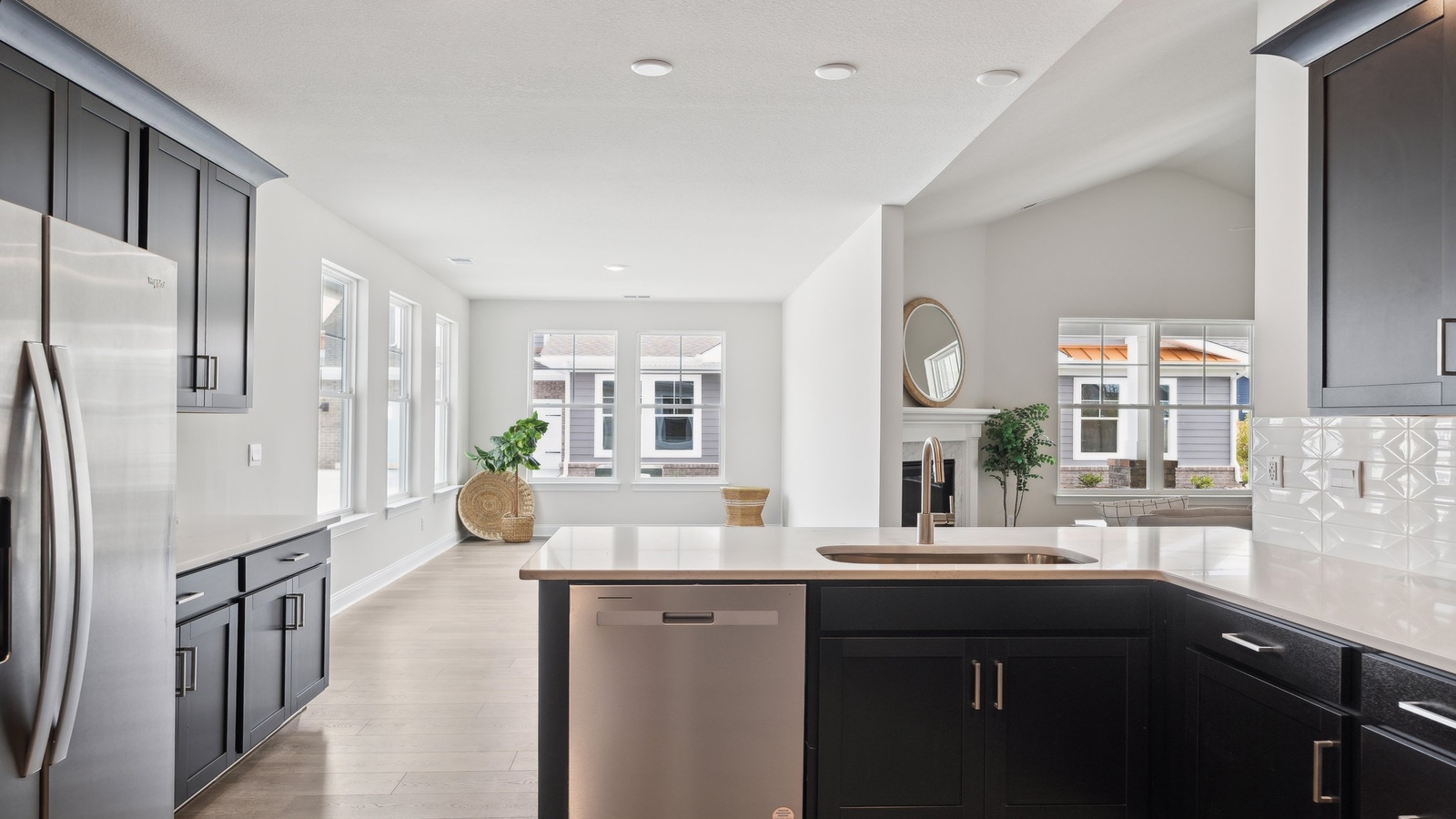 New Build Home kitchen showcasing large center island with LED lighting, new appliance suite, multiple seating options