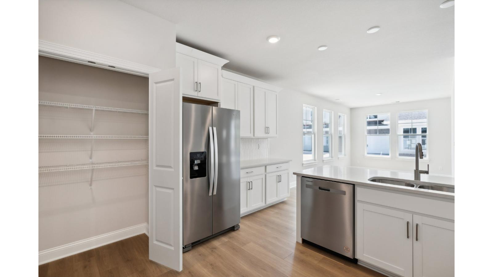 Our kitchen features a large island with seating, pantry, New appliance suite, and Modern Design finishes near main living areas
