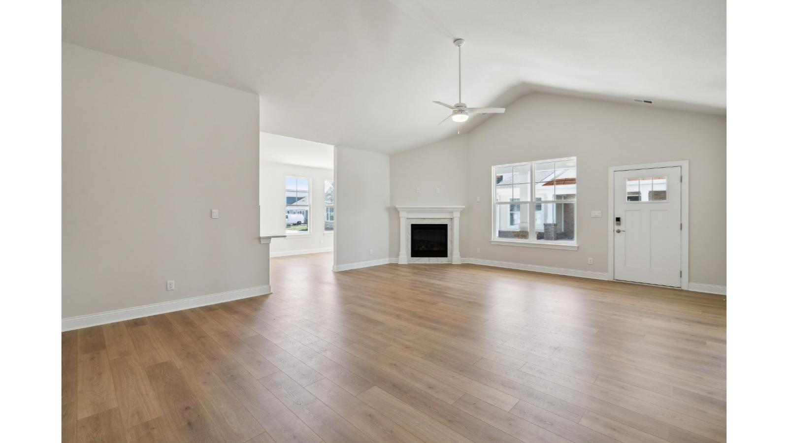 Main living space at Retreat at Edinburgh Farms offering natural light and open layout between kitchen, dining, and living room
