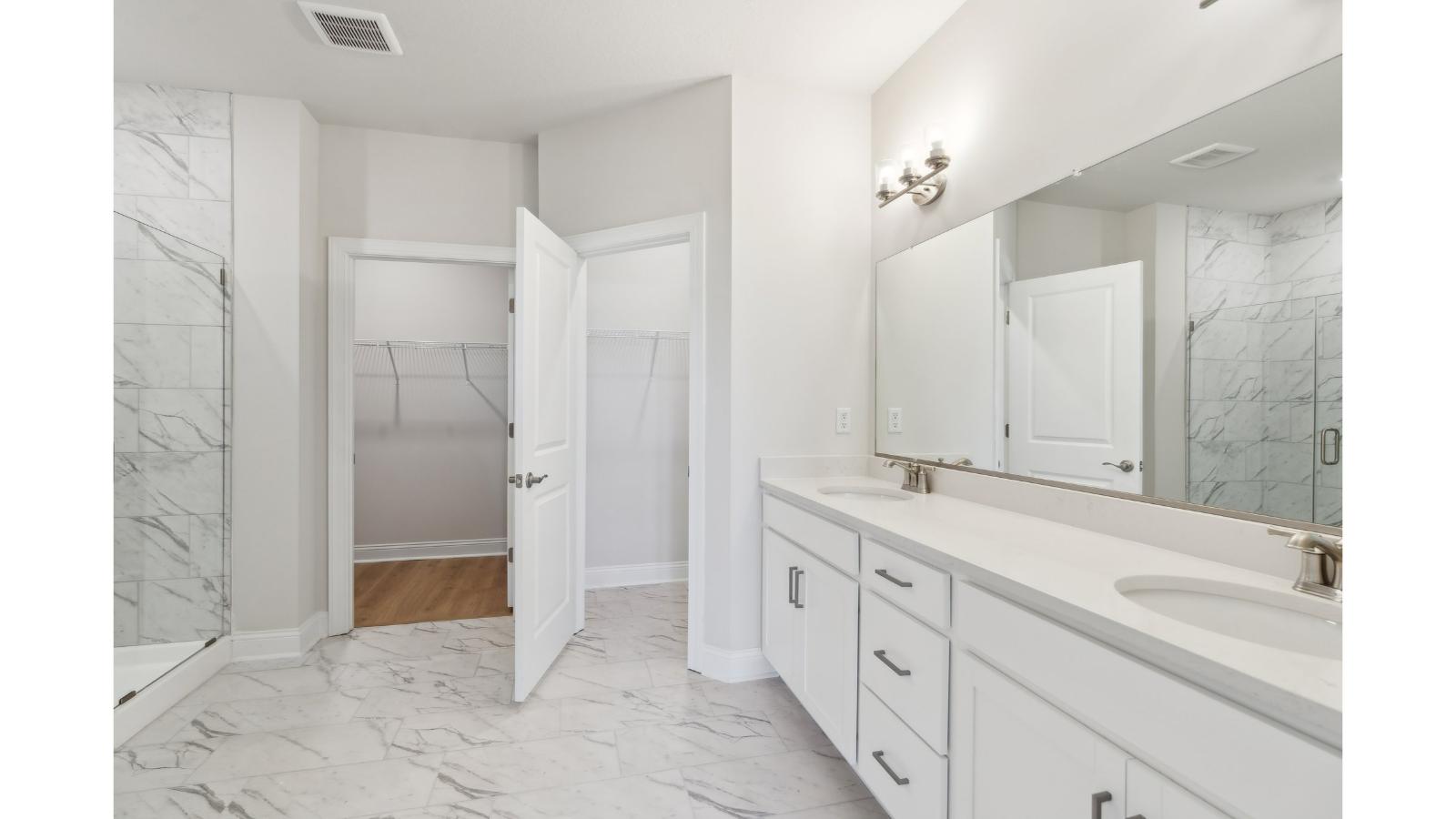 Primary en-suite bathroom in this D.R. Horton New Home featuring dual sinks, expansive vanity, shower-tub, Walk-in Closet