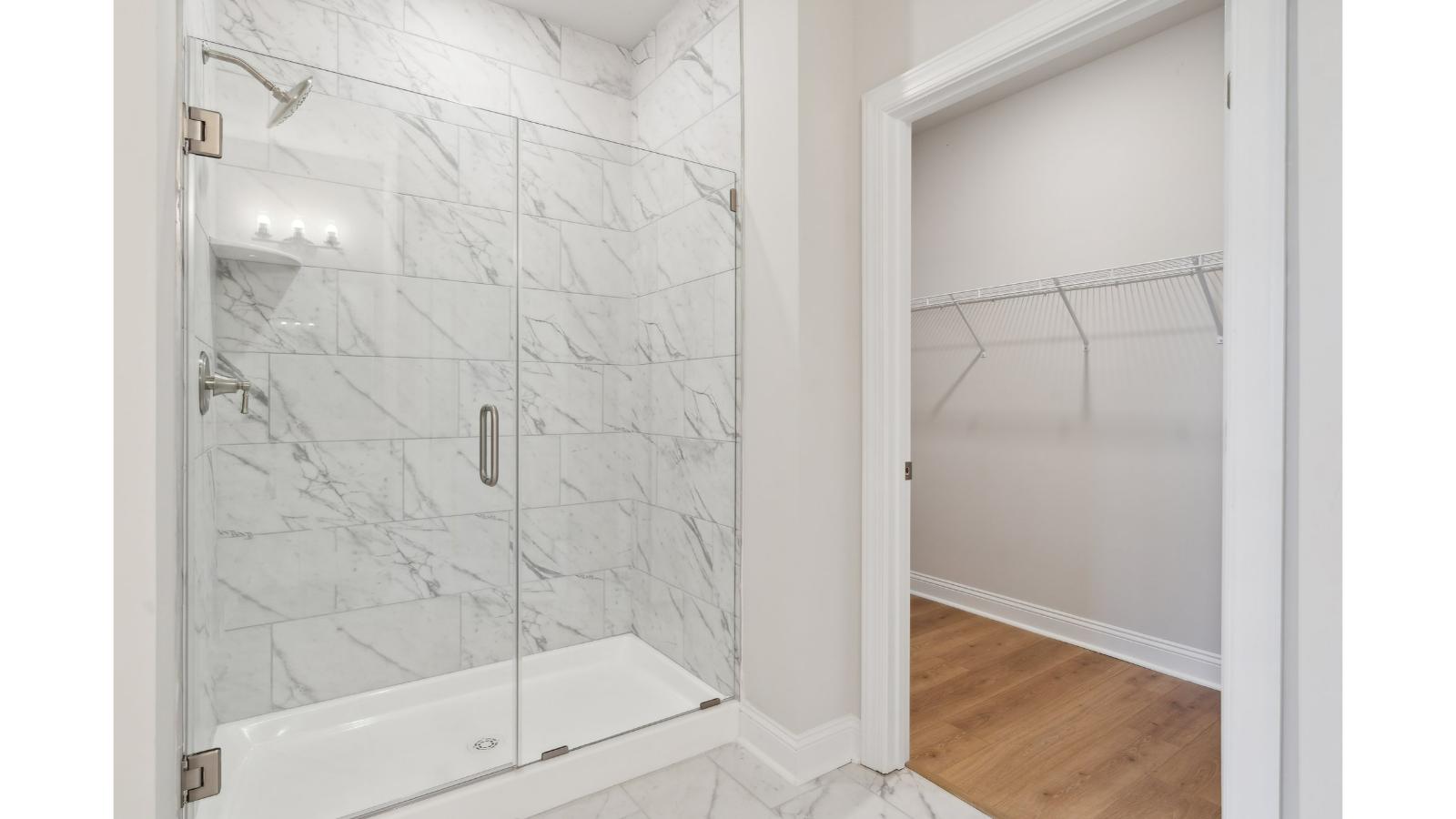 Primary bathroom in this New Build Home includes extended vanity, quality cabinets, walk-in closet and spa-inspired design