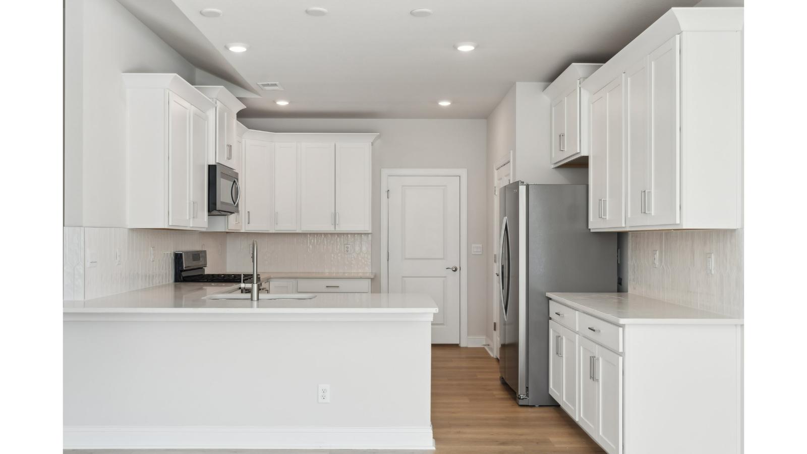Functional kitchen island with ample storage options including a pantry, and New appliances, prep zones