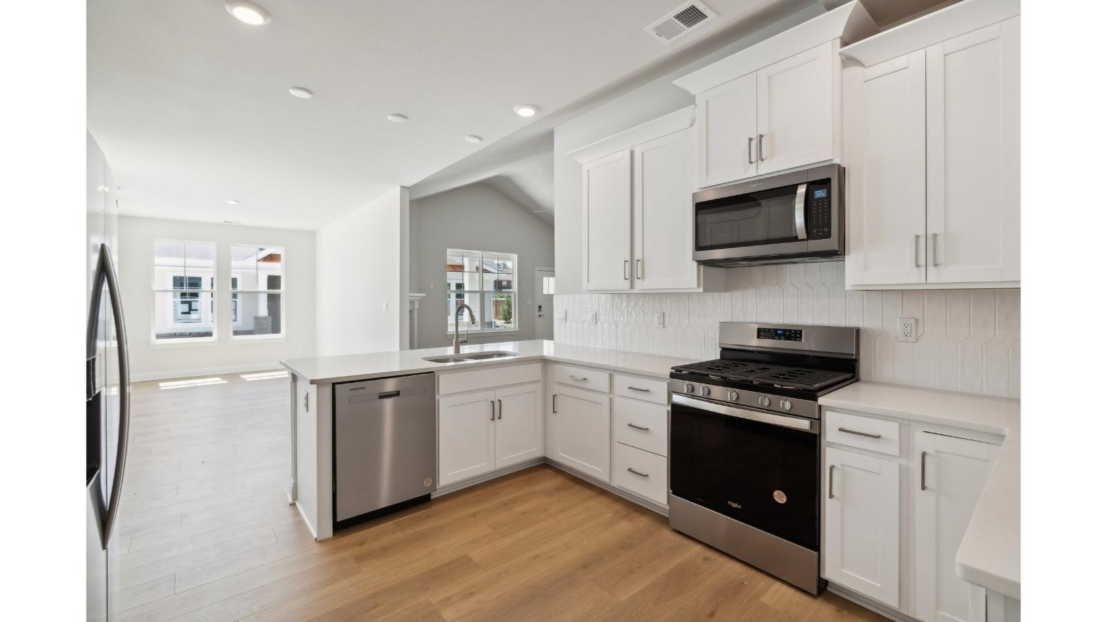 Central kitchen island with dining crafted to anchor the home with pantry, meal prep zones, guest and everyday gathering