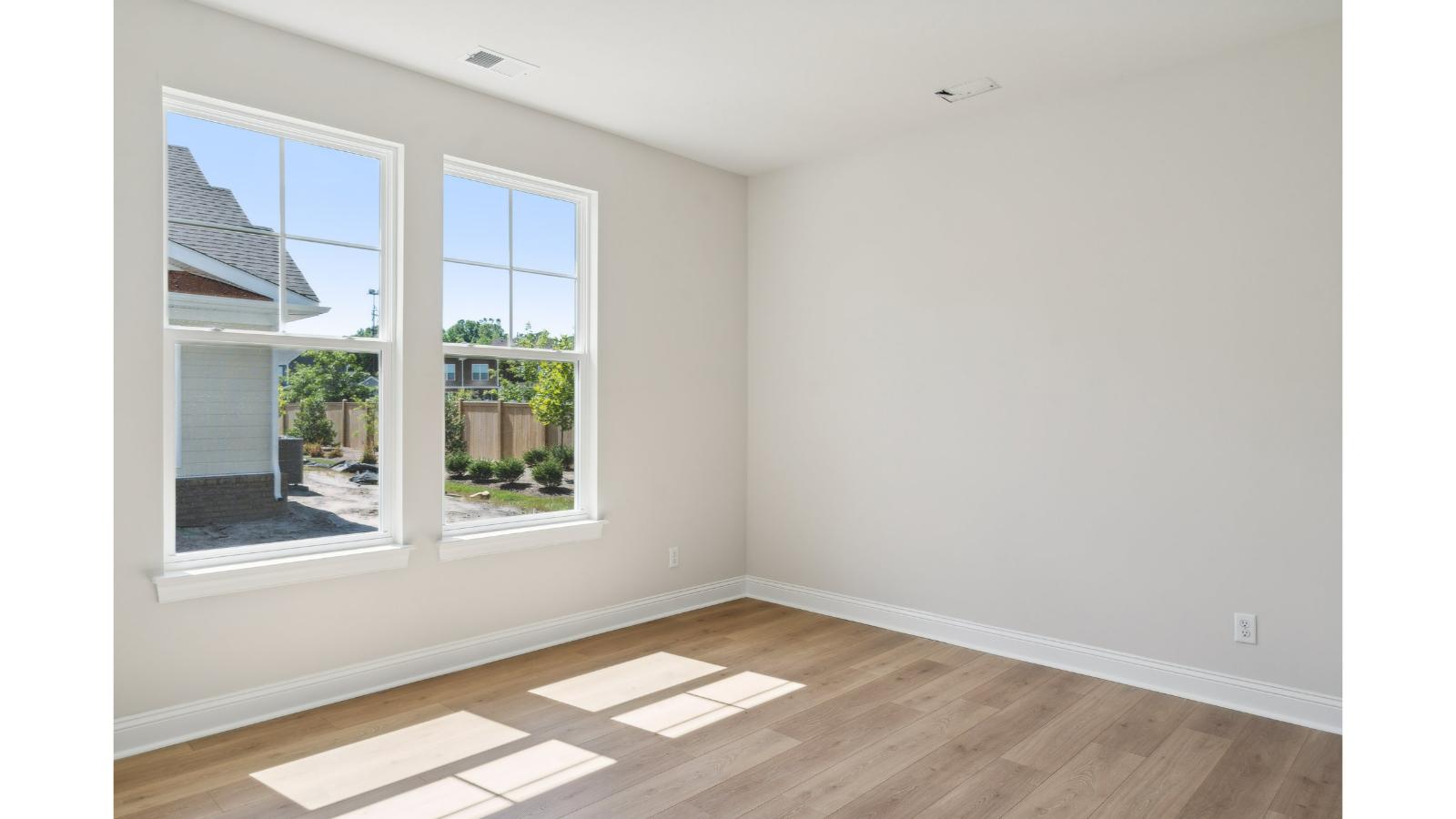 Primary bedroom in this New Home features ample space, double windows, quality carpet, a Walk-in Closet, private En-Suite Bath