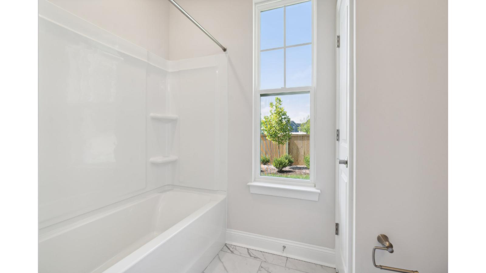 Secondary bath with built-in tub-shower combo, vanity lighting, and stylish finishes in Retreat at Edinburgh Farms