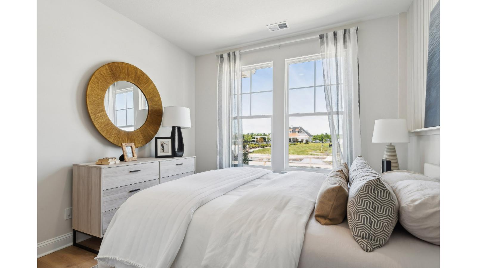 Primary bedroom designed for privacy and space with clean lines and a convenient flow into en-suite bathroom and walk-in closet