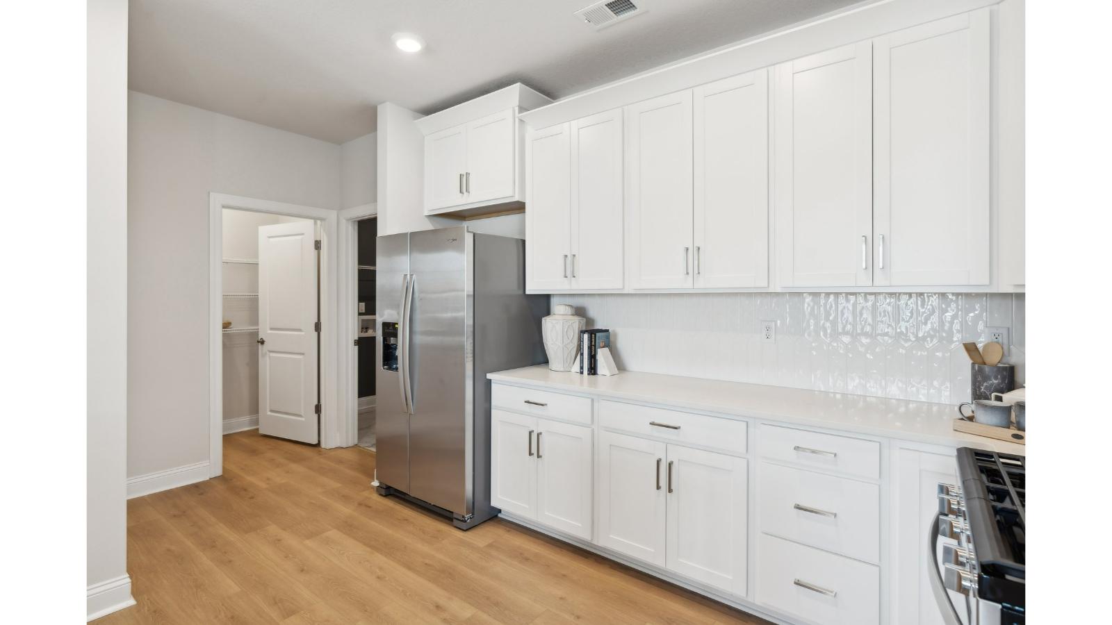Central kitchen island with seating anchors our main level with meal prep zones, new appliance suite, dining-living areas