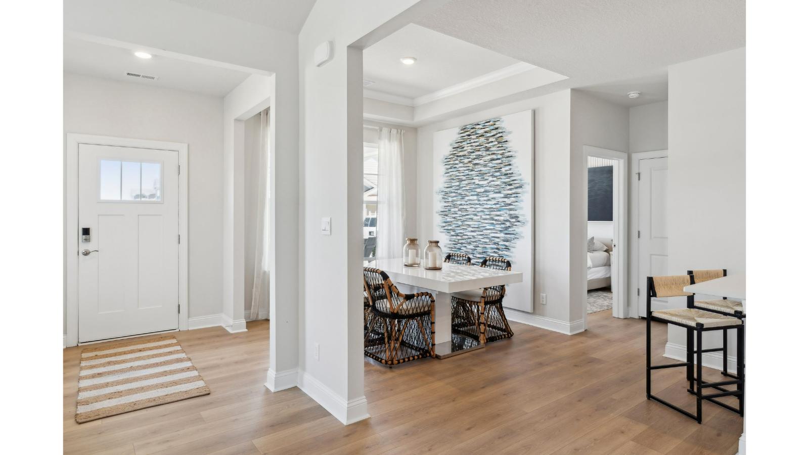Front hallway with natural light, modern door design, and interior sightlines throughout Retreat at Edinburgh Farms