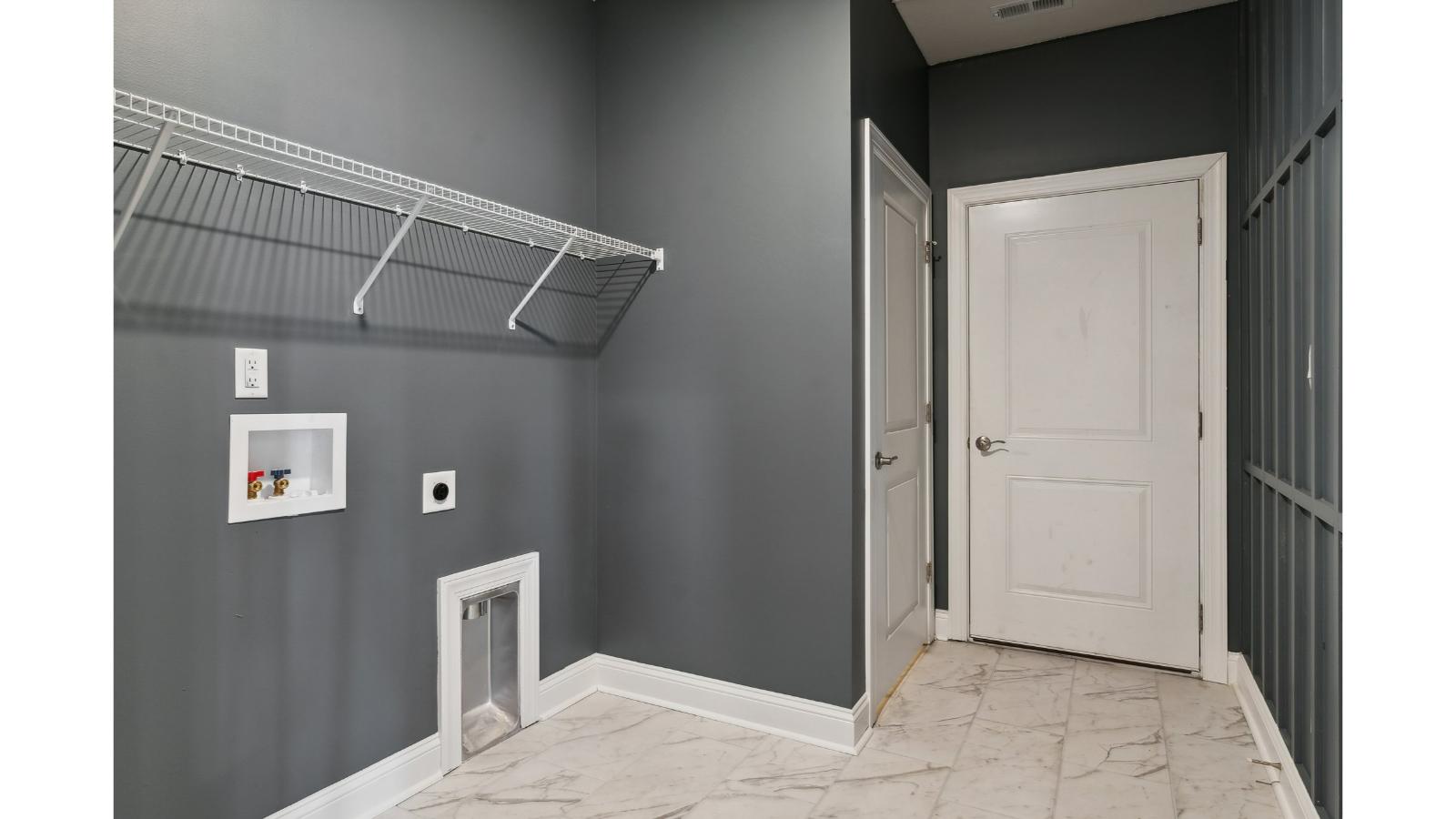 Primary suite walk-in closet in Retreat at Edinburgh Farms new home with built-in shelving and generous storage space