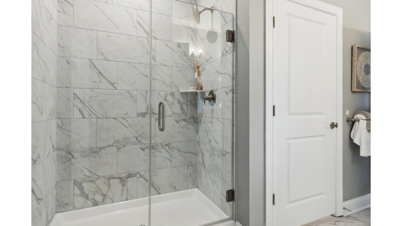 Primary bathroom in this New Build Home includes extended vanity, quality cabinets, walk-in closet and spa-style layout