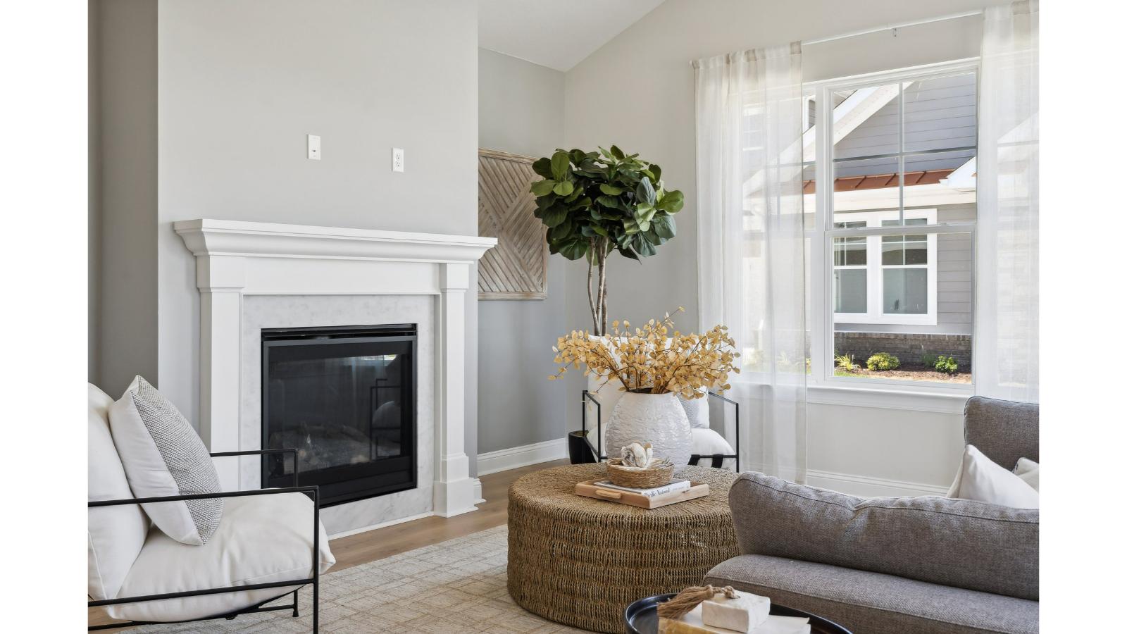Front living room with two-story height in Retreat at Edinburgh Farms home offering natural light