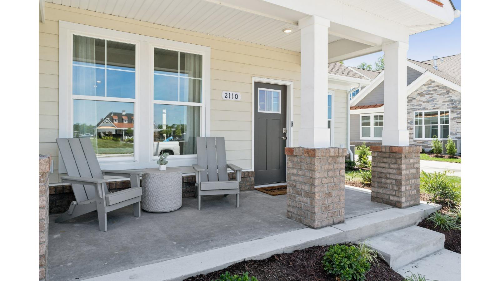 Neighborhood street view of Retreat at Edinburgh Farms community by D.R. Horton with fresh front porch designs, curb appeal