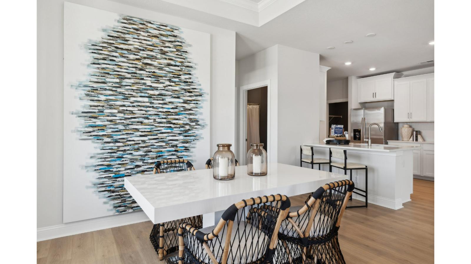 Dining area with nearby kitchen island, backyard view and open-concept plan for entertaining Retreat at Edinburgh Farms