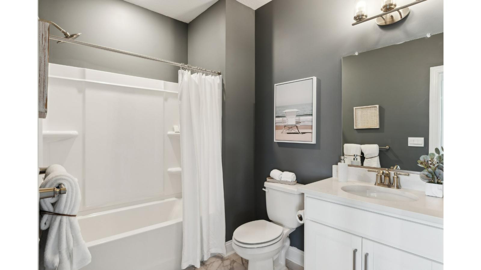 Primary bathroom in this New Build Home includes extended vanity, quality cabinets, walk-in closet and spa-style layout