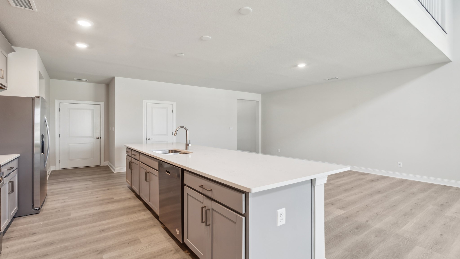 Spacious kitchen in this New Construction House featuring a bright layout, pantry, upgraded island, new appliance suite.