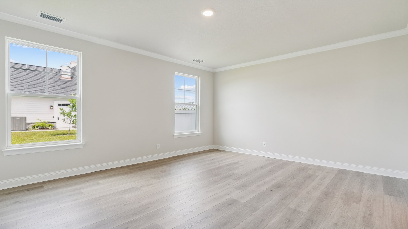 Spacious primary bedroom in our New Construction Home includes Modern Design finishes and quiet rear-facing windows.