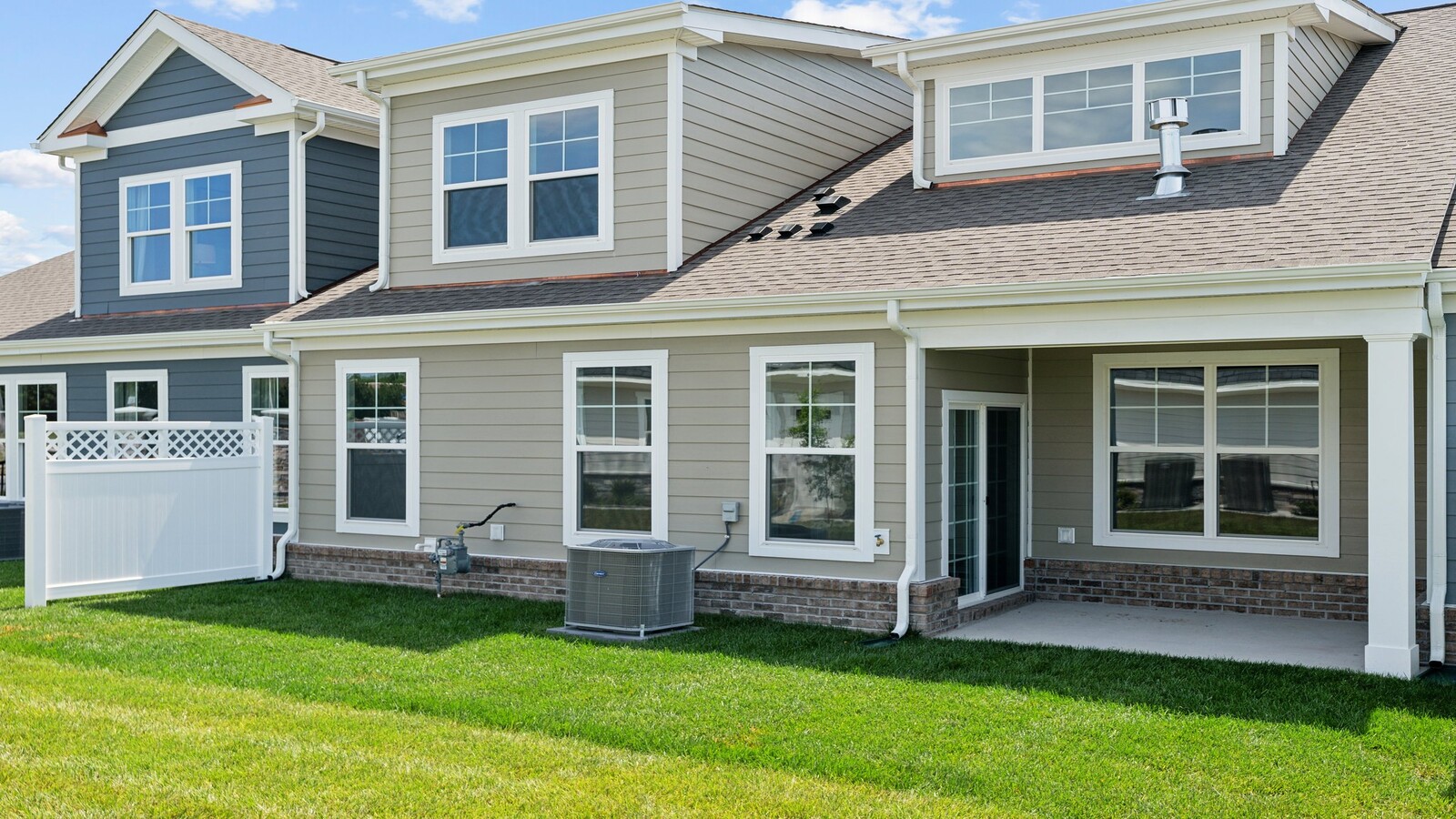 Rear covered patio connected to dining - family room offering outdoor access in this New Construction Home