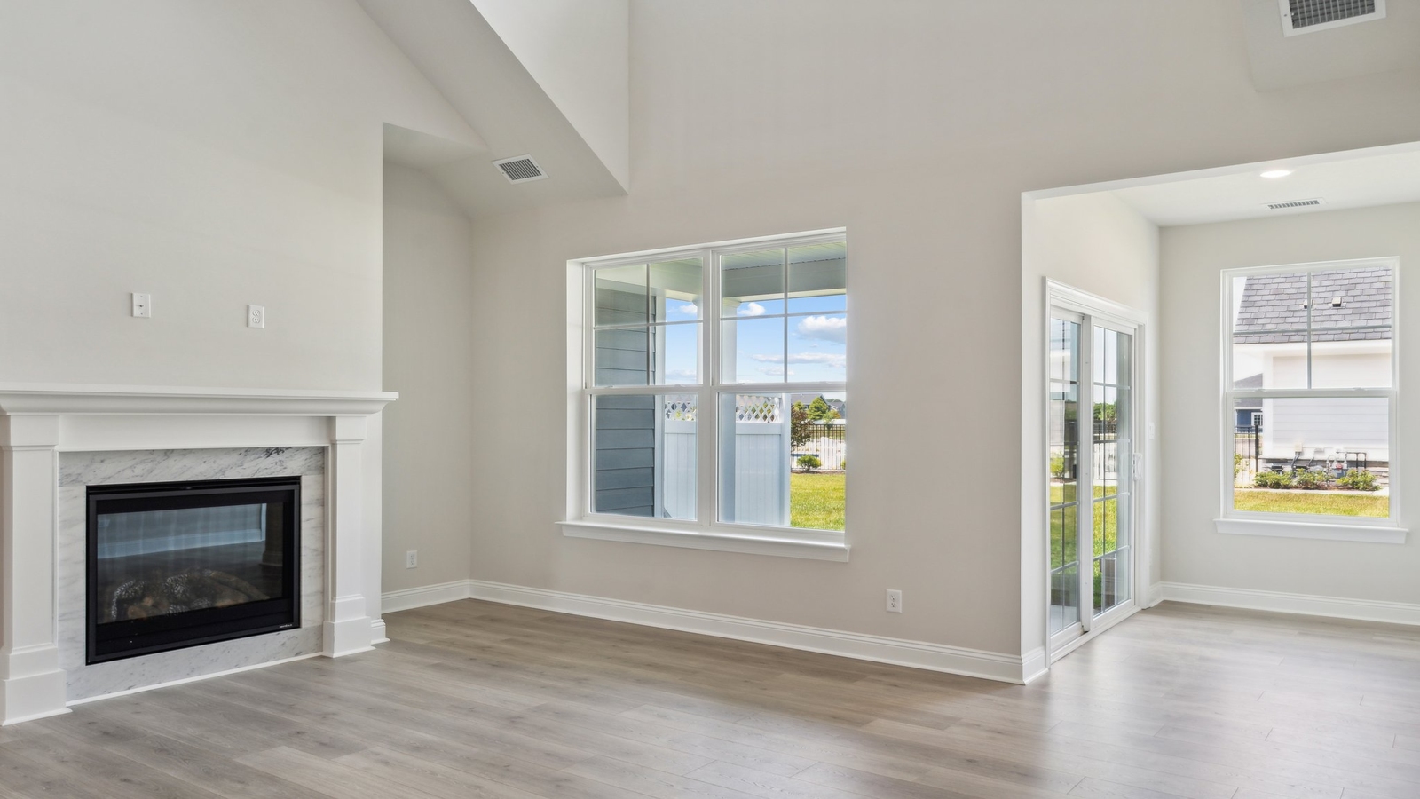 Living room with modern fixtures, electric fireplace, convenient central traffic flow throughout Retreat at Edinburgh Farms
