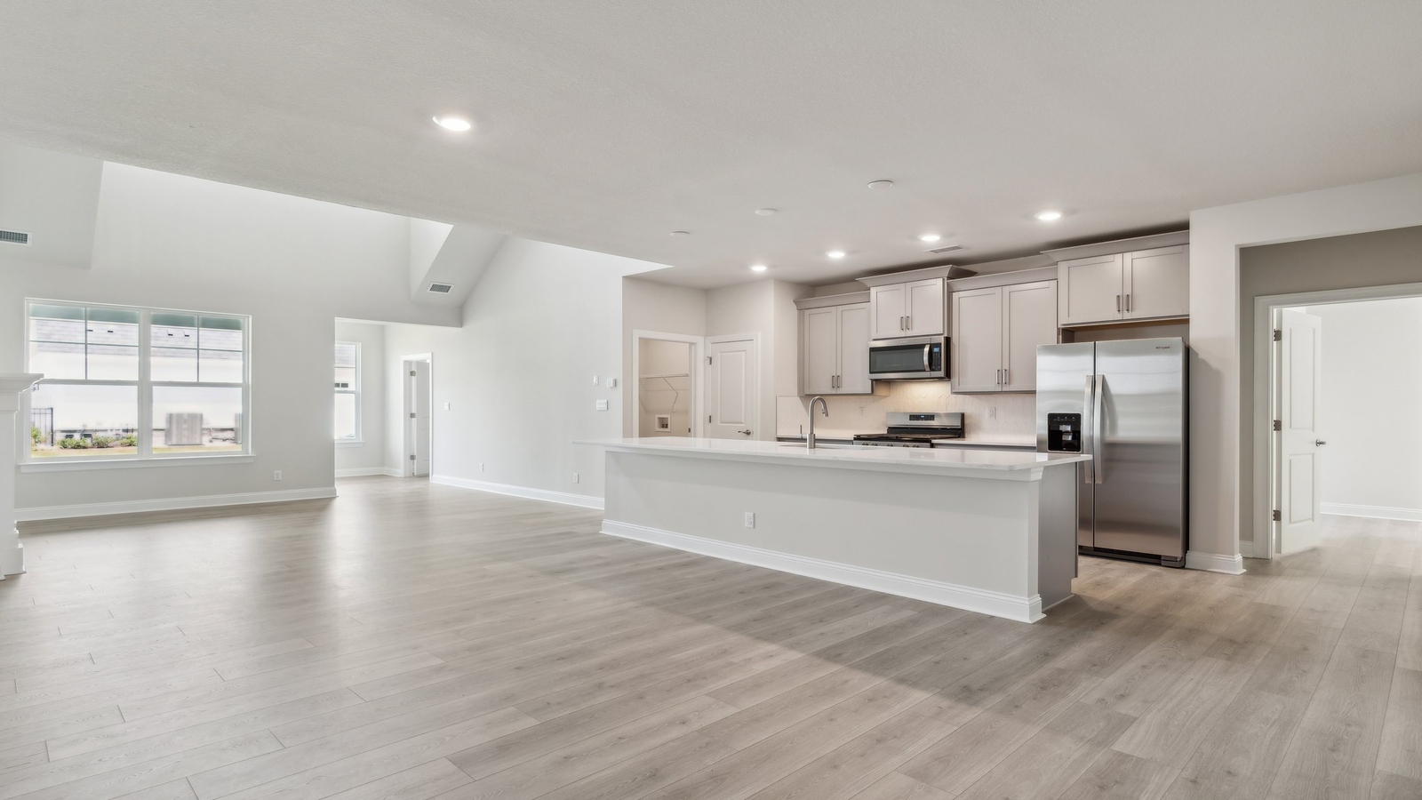 Our kitchen features a large island with seating, pantry, New appliance suite, and Modern Design finishes near dining, living