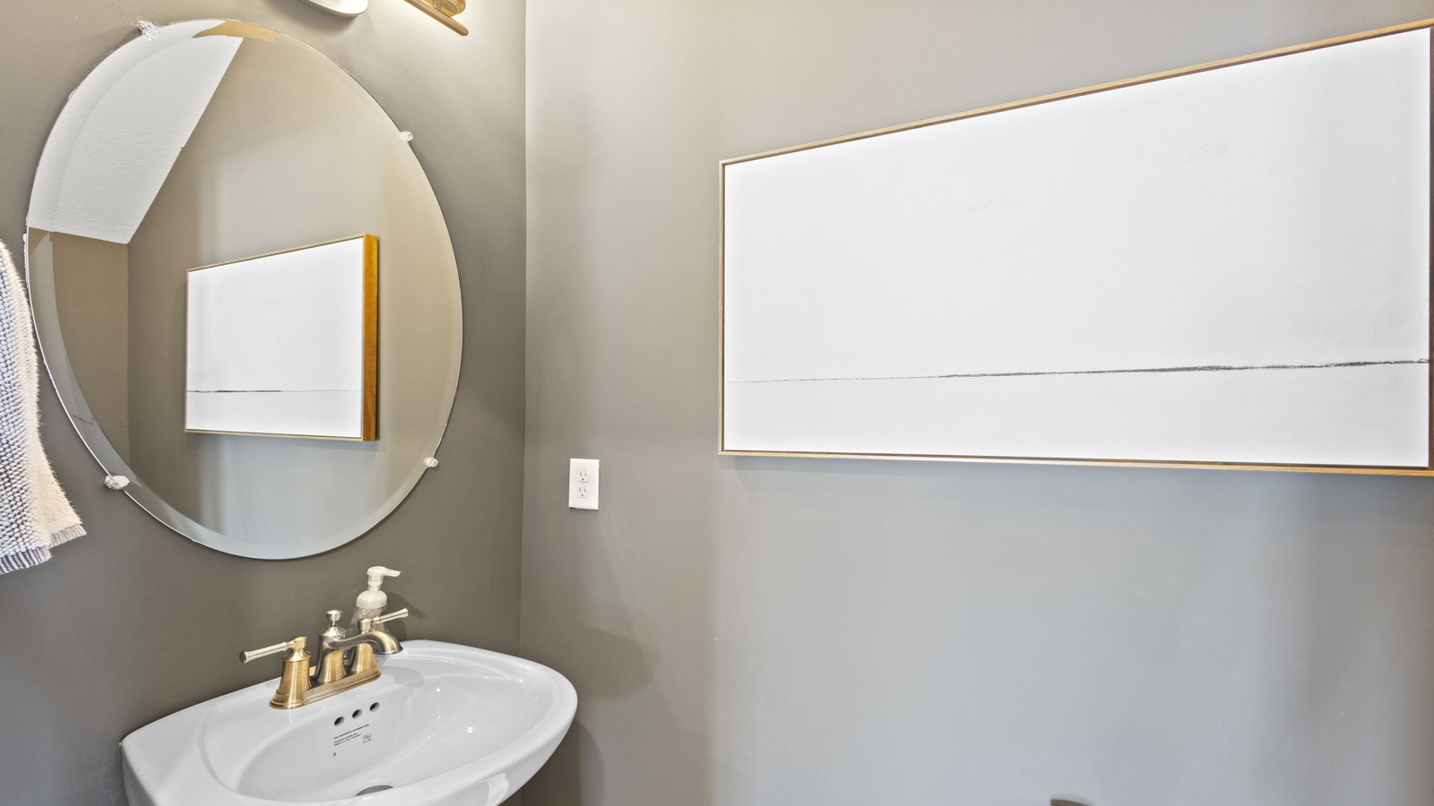 Half bath with door open to hallway, pedestal sink visible with silver faucet in Retreat at Edinburgh Farms