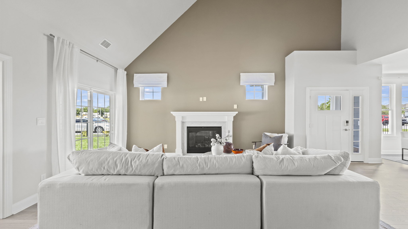 Living room built for daily living with ample space, electric fireplace, simple Fresh Open Concept 2-story designs
