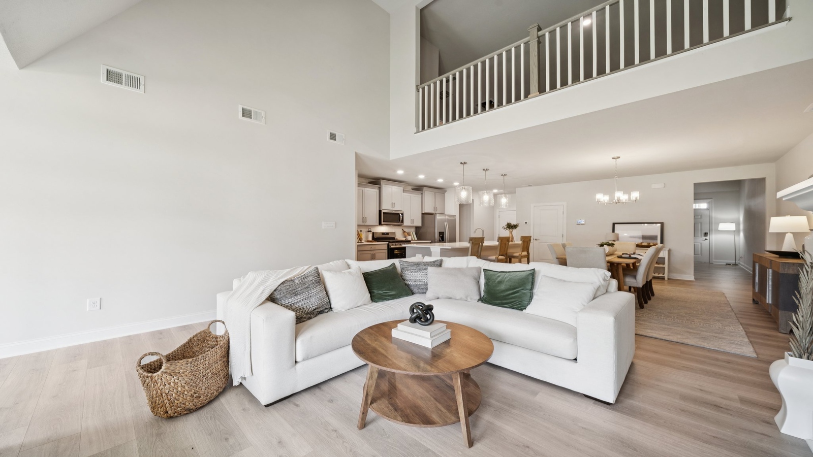 Two-story living room at the front of Country Club Villas home off the main entryway by D.R. Horton