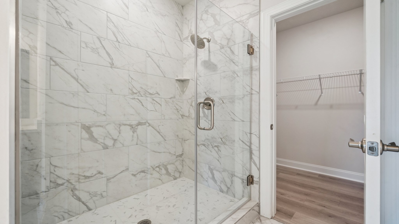 Bright and open primary bedroom in Country Club Villas with walk-in closet, en-suite bath, large window overlooking backyard.