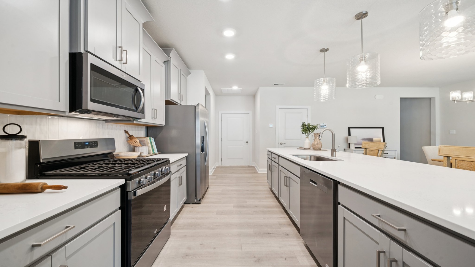 New appliances suite, overhead cabinetry, pantry, island seating in Country Club Villas kitchen-family-dining areas