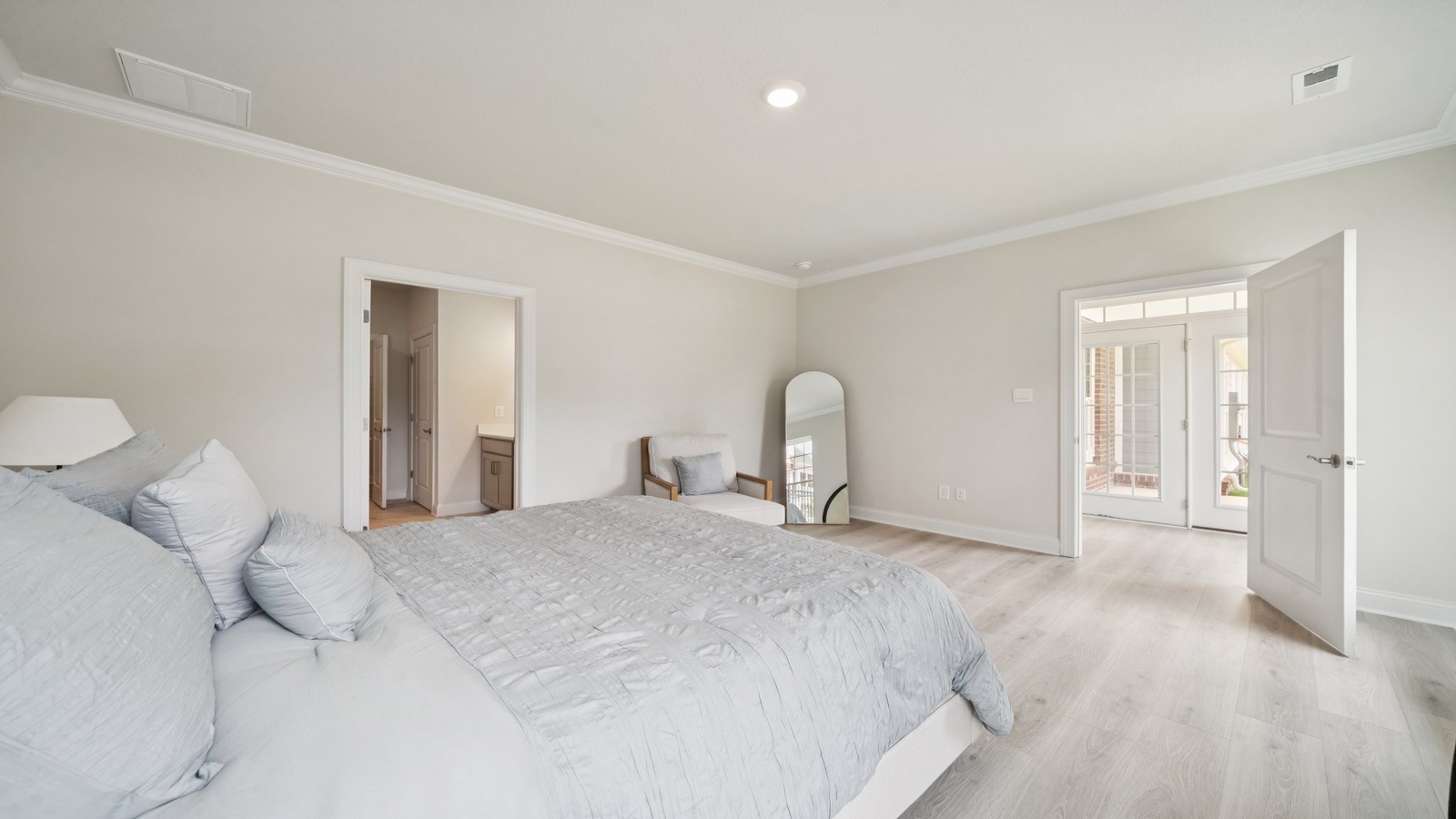 Primary bedroom designed for privacy and space with clean lines and a convenient flow into en-suite bathroom and walk-in closet