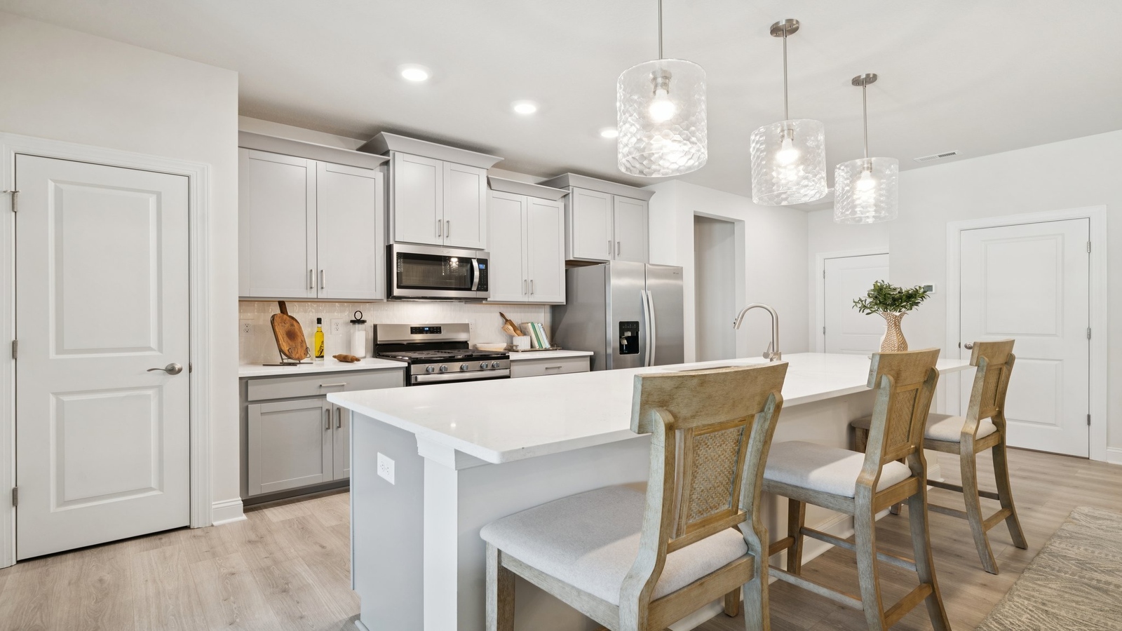 Kitchen with new appliances, LED lighting, and cabinet finish options at Country Club Villas