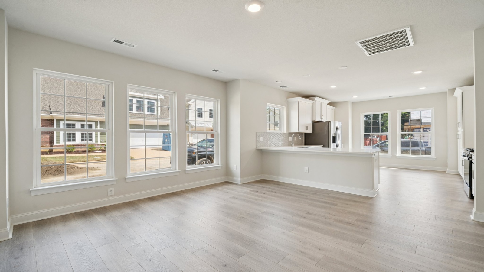 Kitchen island with new appliances, sink, and cabinet options overlooking Living - Dining room at Country Club Villas