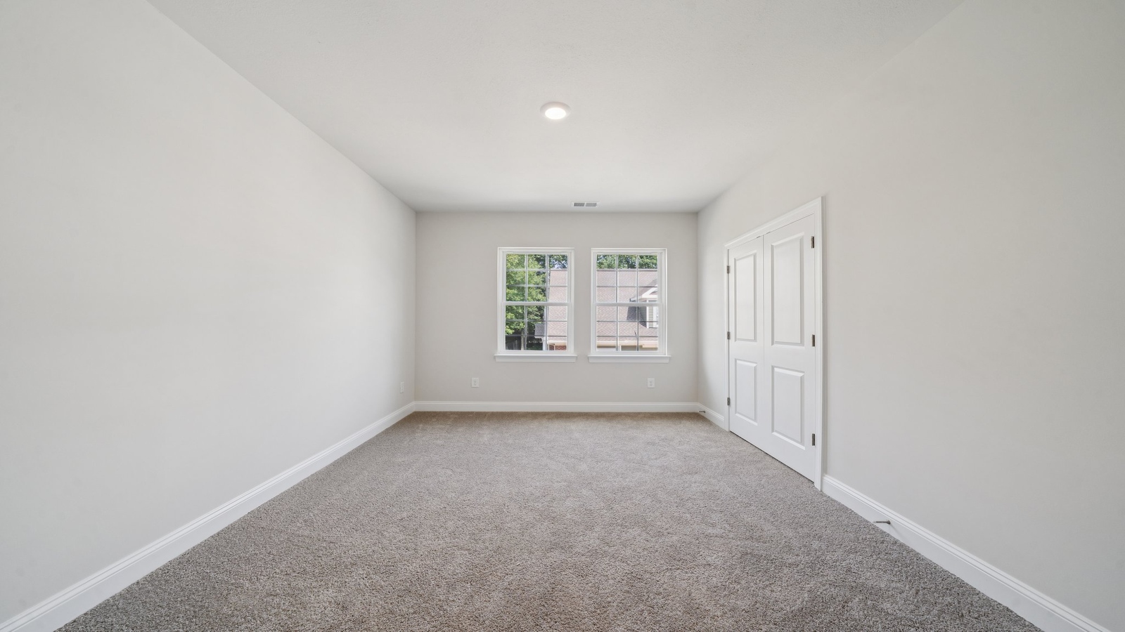 Secondary Bedroom in this New Home includes stellar carpet, bright window light, closet, ideal for guest or child use