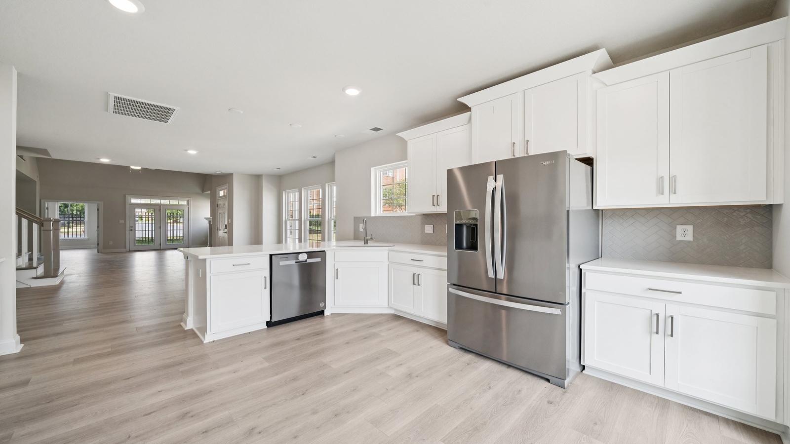 Kitchen-dining-family room combo in this New Home includes Modern Design elements throughout.